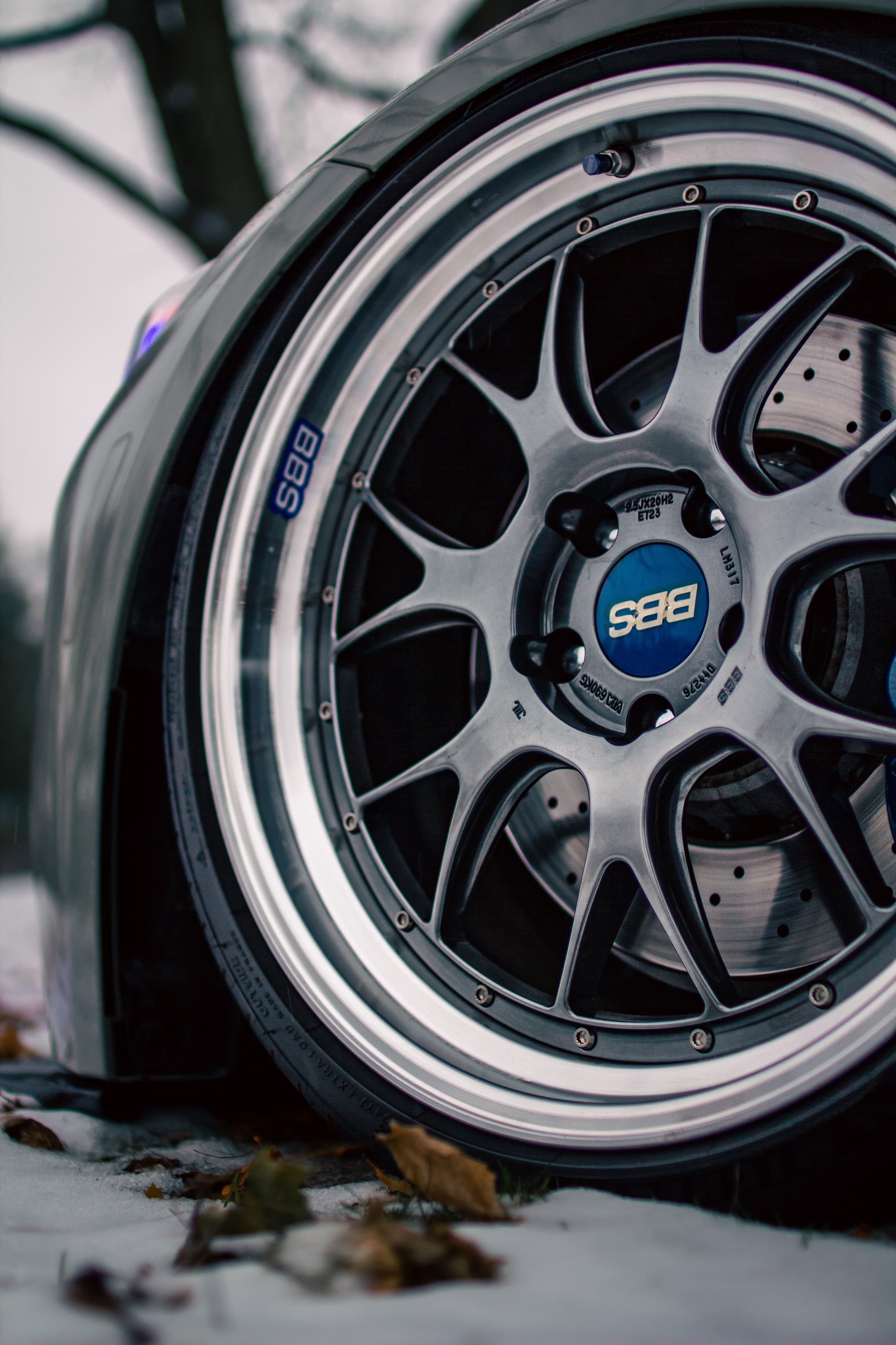 Close view of the BMW M3's BBS wheel with snow beside the tyre