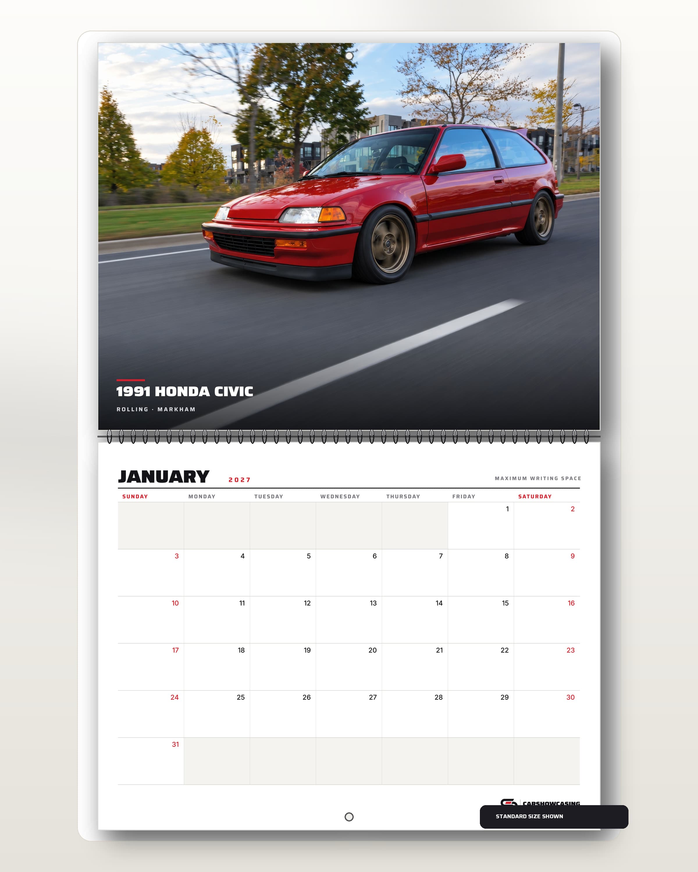 Open 2027 Civic wall calendar: a red 1991 Honda Civic hatchback rolling under fall trees above the January writing grid