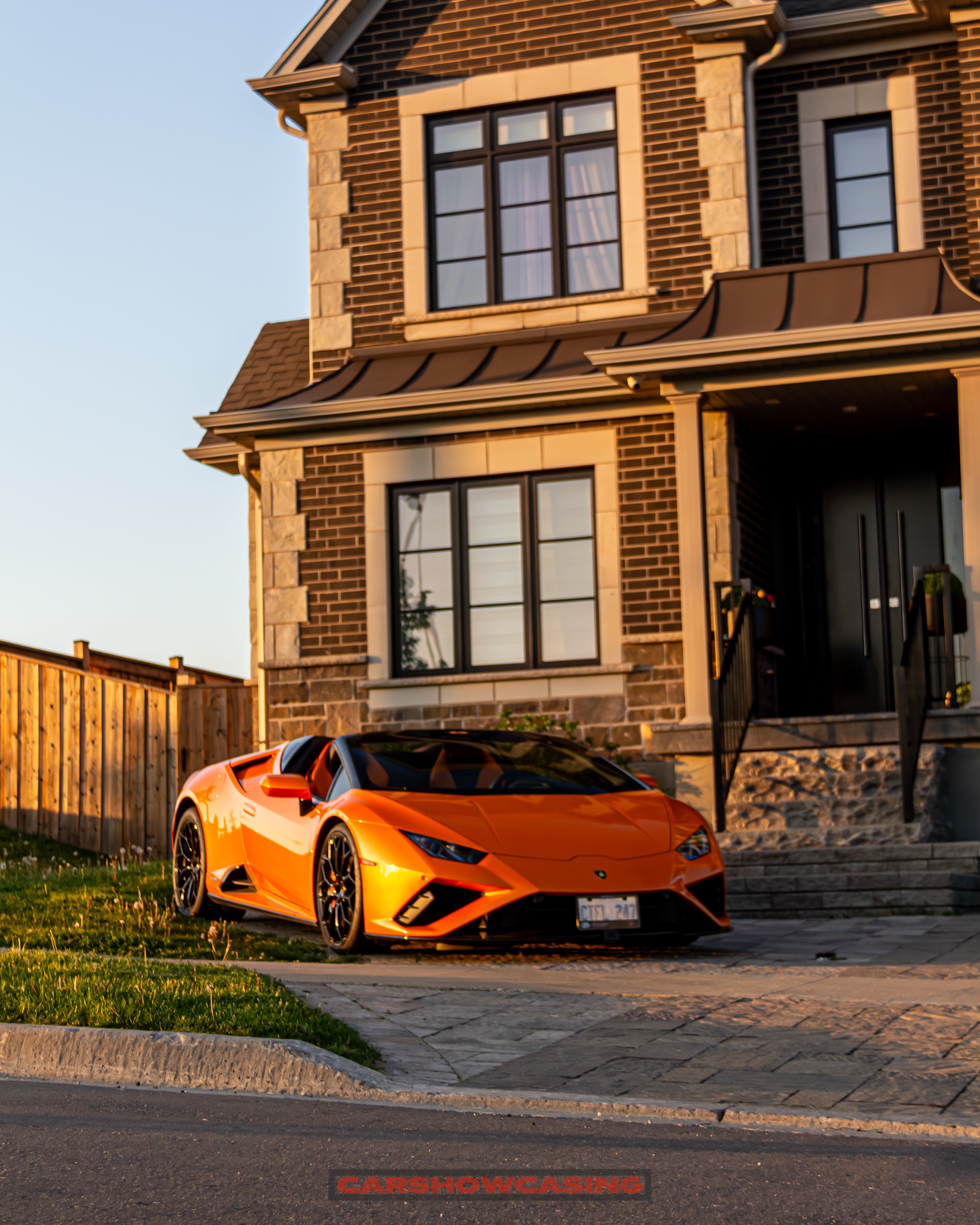 lamborghini huracan infront of a house on cobble driveway